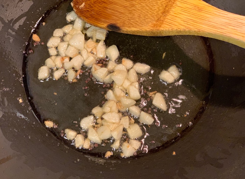 5. Tadka, chooped garlic getting golden brown.